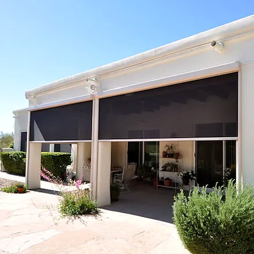 Retractable exterior sun shades installed on a covered patio