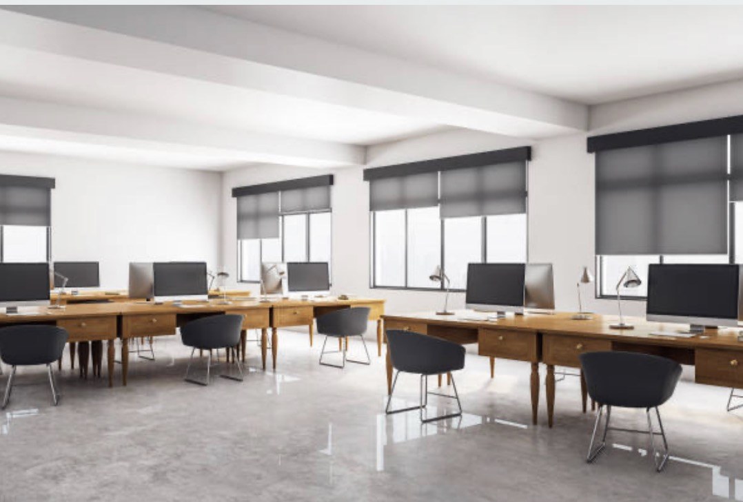 Office roller shades over desks